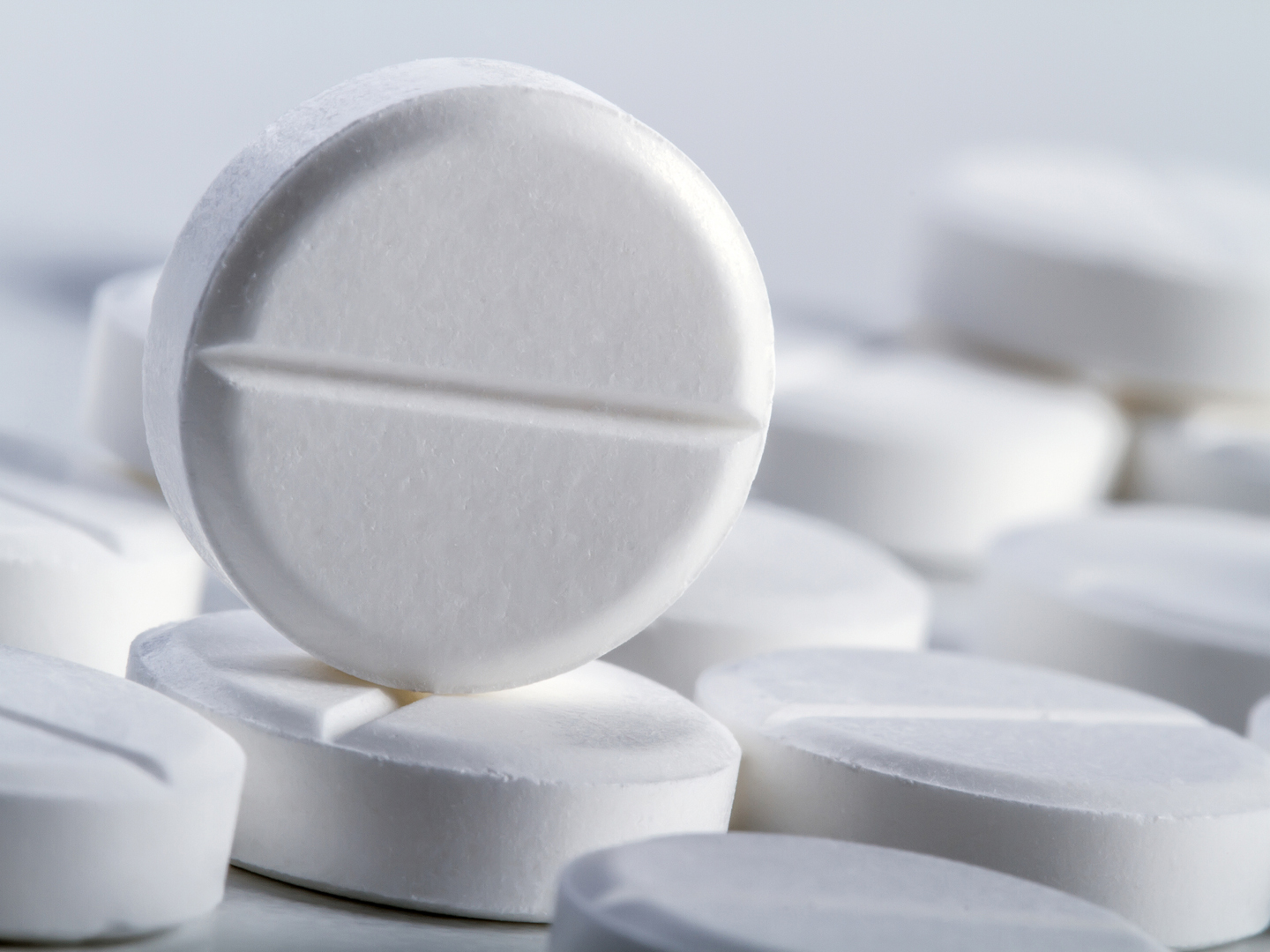 Several tablets or pills on a white background