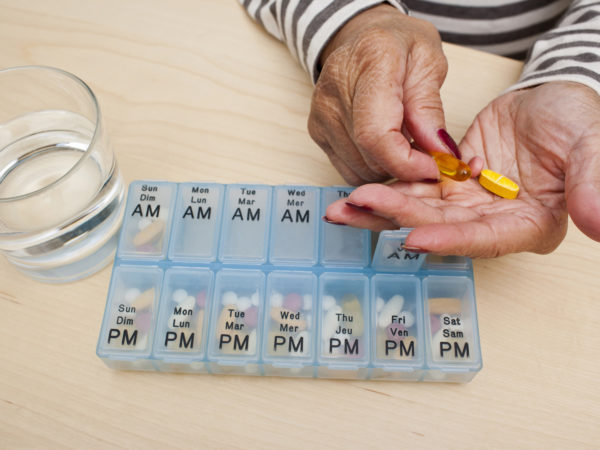 Elderly woman takes her medicine