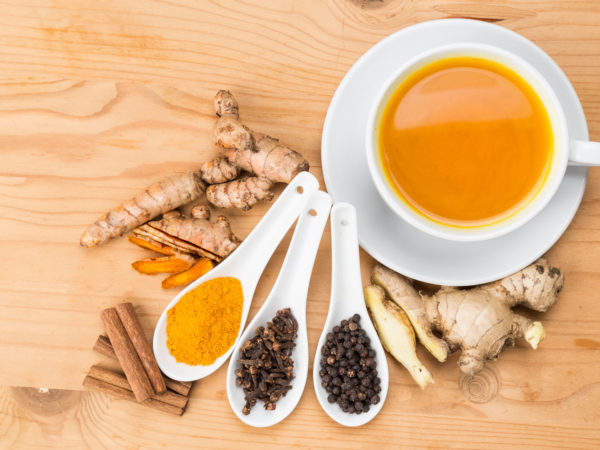 Aromatic turmeric tea with black pepper, cinnamon, cloves and ginger offers many wellness health benefits