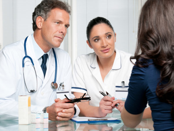 Young female patient discuss with doctors on her medical exam at hospital.