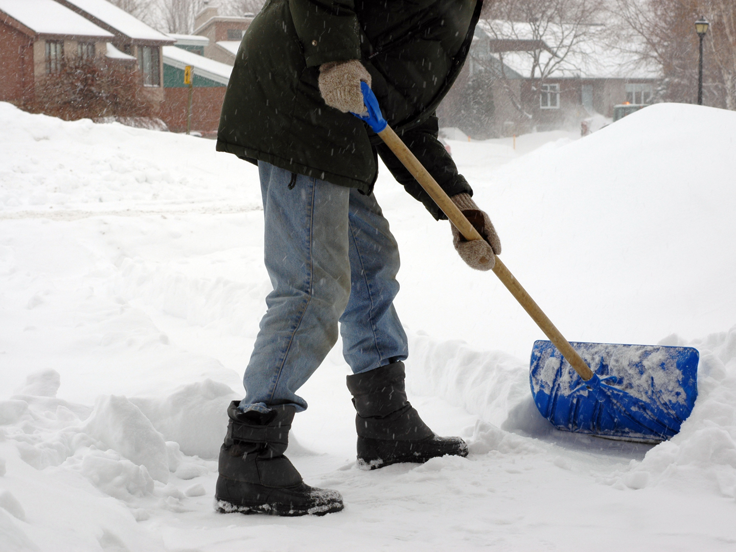 Man shoveling snow. Winter morning - Canada