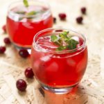 Cranberry cocktail with mint on a wooden table