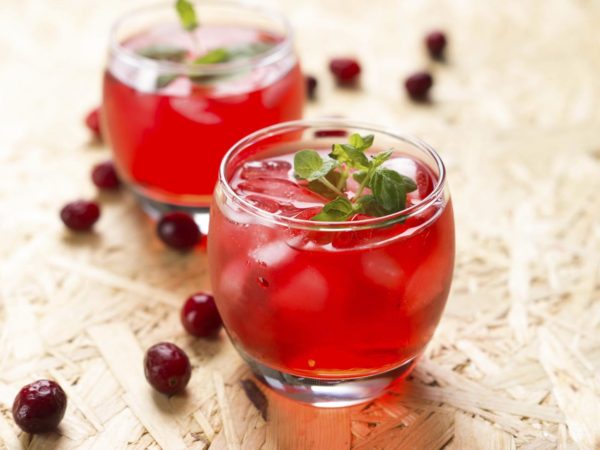Cranberry cocktail with mint on a wooden table