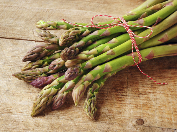 fresh green asparagus over wooden background