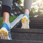 Athlete runner feet running in nature, closeup on shoe. Female athlete running on stairs. Woman fitness, running, jogging, sport, fitness, active lifestyle concept