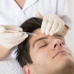 Young Man Having Botox Treatment At Beauty Clinic