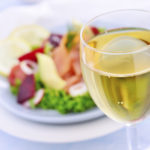 White wine with salmon salad at the background