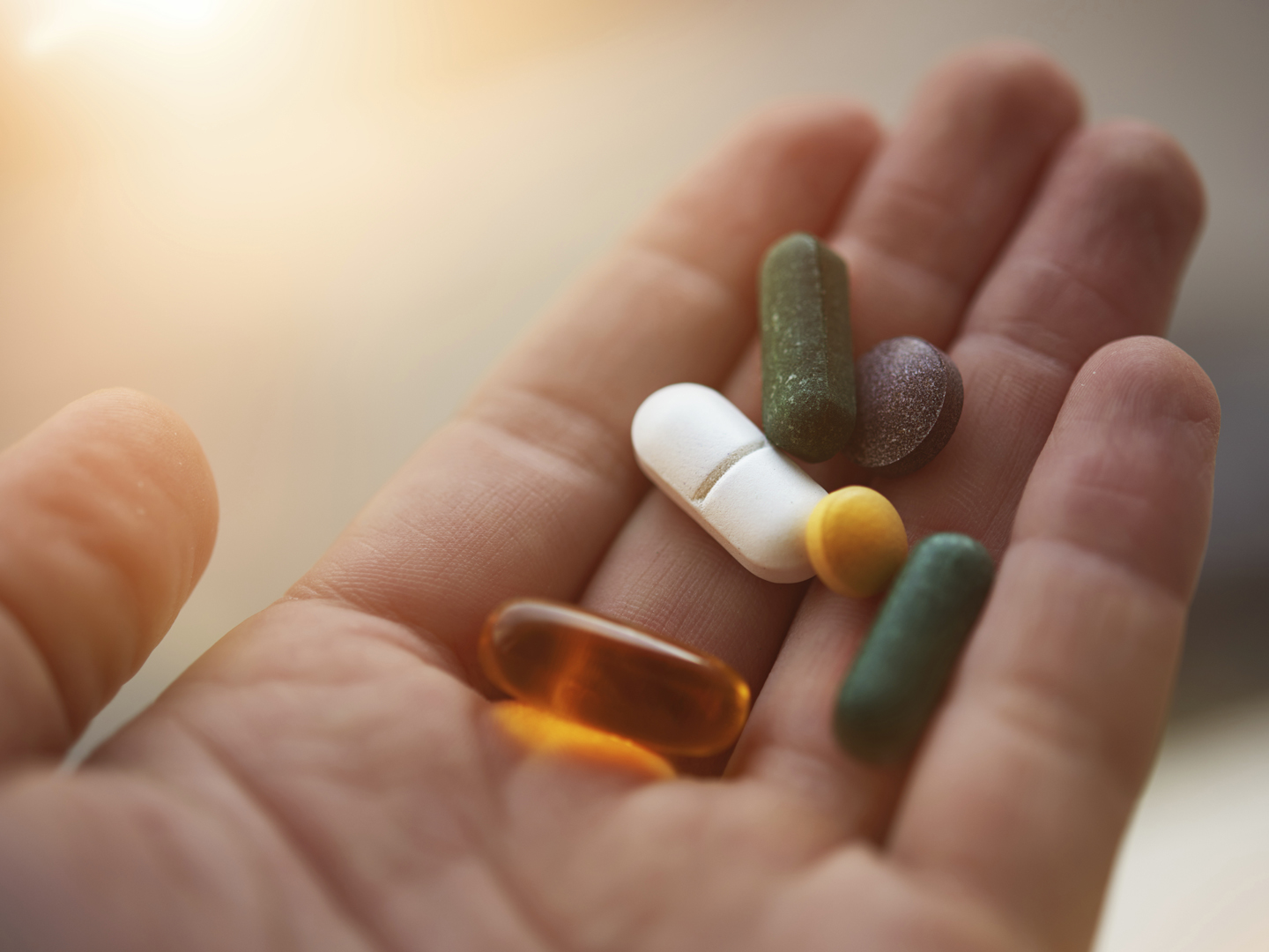 man hand holding his nutritional supplemets, healthy lifestyle background.