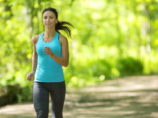 Picture of a woman jogging in a park.