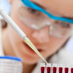 laboratory assistant analyzing a blood sample