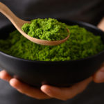 Wolffia or watermeal in bowl and spoon holding by hand, Healthy edible small aquatic plant high protein and fiber