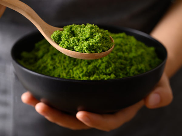 Wolffia or watermeal in bowl and spoon holding by hand, Healthy edible small aquatic plant high protein and fiber
