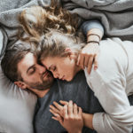 Couple_Hug_Bed_Grayblankets