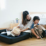 Young asian mother and son getting ready to vacation